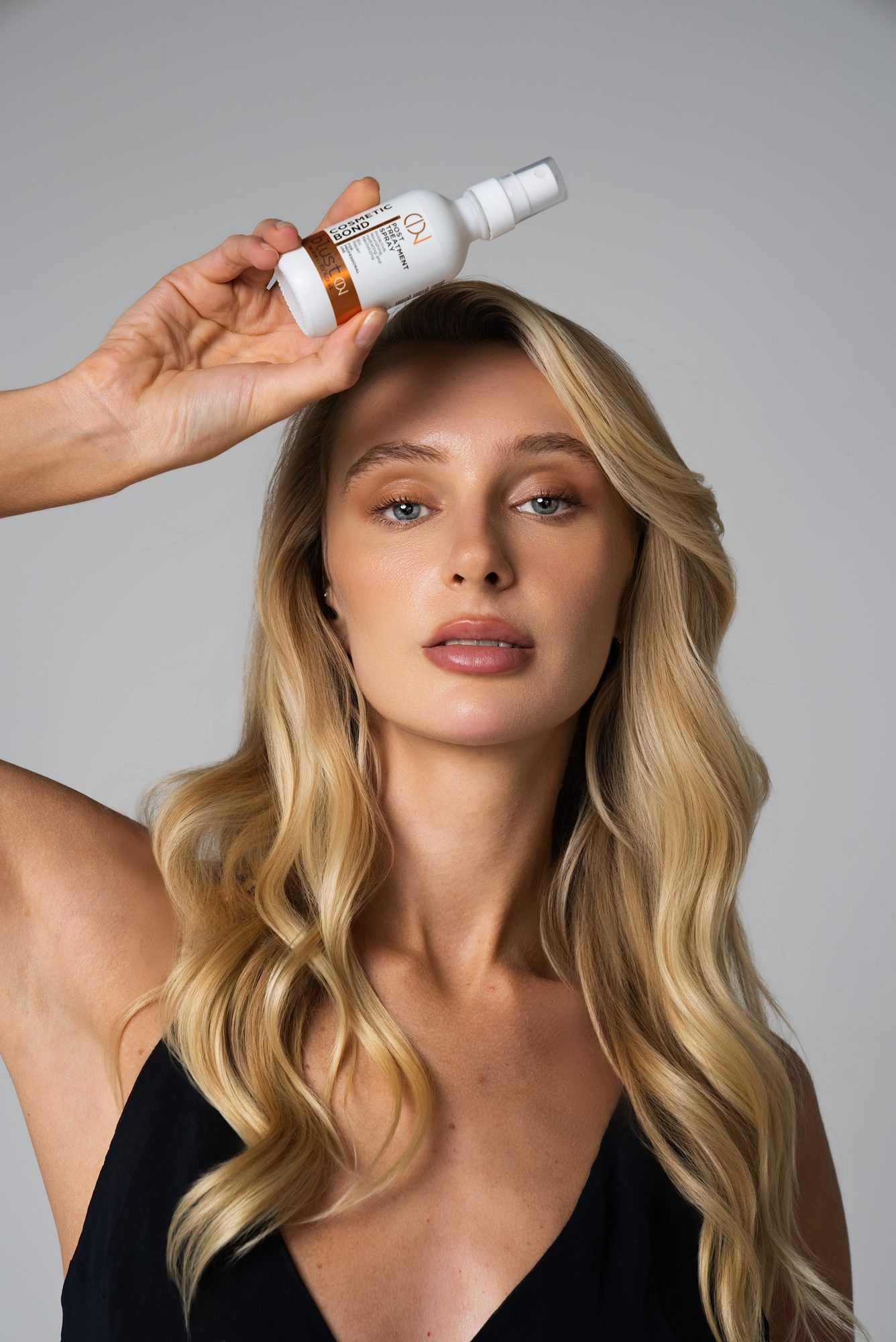 Beauty editorial holding a serum bottle